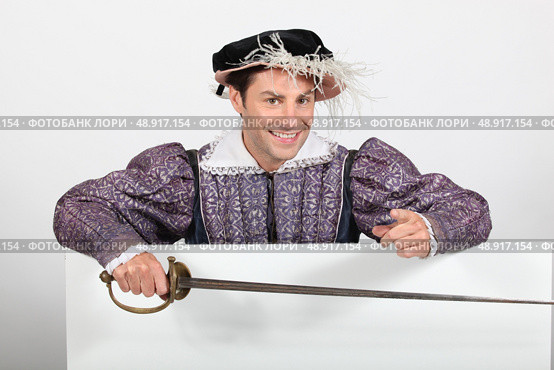 Man in fancy dress stood with blank advertising board. Стоковое фото, агентство Ingram Publishing / Фотобанк Лори