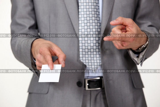 Man pointing at business card. Стоковое фото, агентство Ingram Publishing / Фотобанк Лори