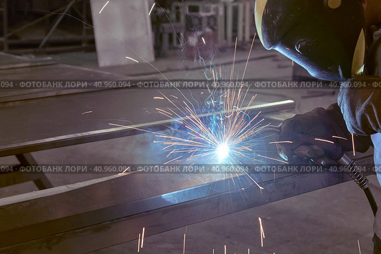 Man processes metal with gas electric welding. Стоковое фото, фотограф Стас Пересыпкин / Фотобанк Лори