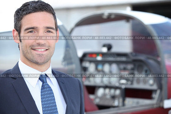 man standing in front of a plane cockpit. Стоковое фото, агентство Ingram Publishing / Фотобанк Лори