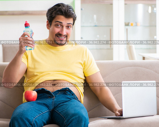 Man suffering from extra kilos in dieting concept. Стоковое фото, фотограф Elnur / Фотобанк Лори