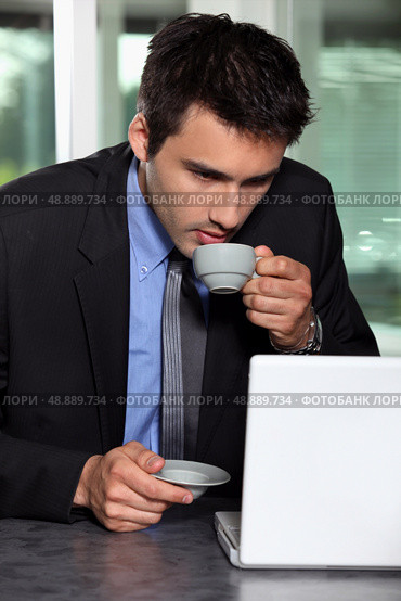 Man with computer and coffee cup. Стоковое фото, агентство Ingram Publishing / Фотобанк Лори
