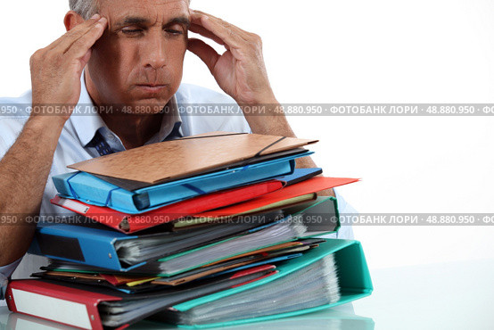 Man with stack of work. Стоковое фото, агентство Ingram Publishing / Фотобанк Лори