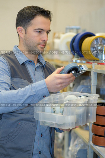 man working at a small wheels factory. Стоковое фото, агентство Ingram Publishing / Фотобанк Лори