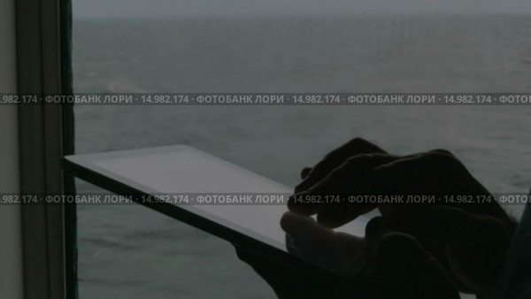 Man working with tablet PC aboard. Стоковое видео, видеограф Данил Руденко / Фотобанк Лори