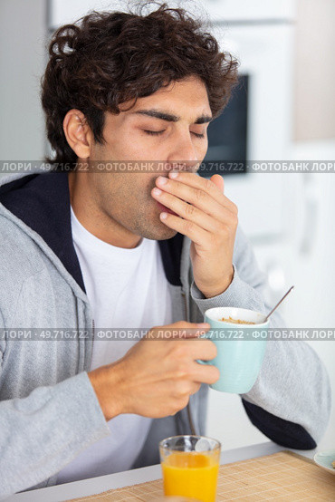 man yawning at the breakfast table. Стоковое фото, агентство Ingram Publishing / Фотобанк Лори