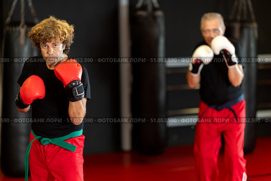 Martial arts fighter preparing for sparring in boxing gloves. Стоковое фото, фотограф Яков Филимонов / Фотобанк Лори