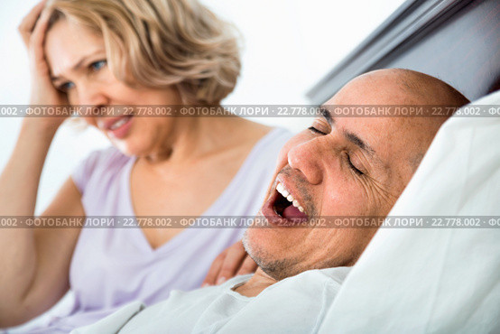 Mature tired girl looking at snoring boyfriend. Стоковое фото, фотограф Яков Филимонов / Фотобанк Лори
