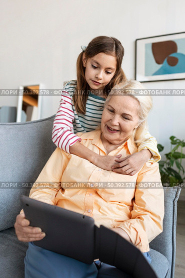 medium shot granddaughter hugging woman. Стоковое фото, агентство Ingram Publishing / Фотобанк Лори