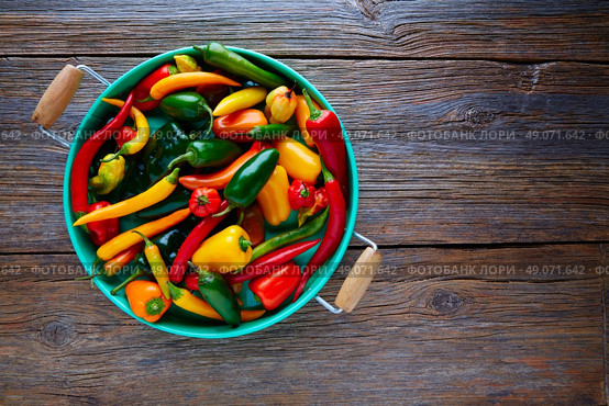 Mexican hot chili peppers colorful mix habanero poblano serrano jalapeno on wood. Стоковое фото, агентство Ingram Publishing / Фотобанк Лори