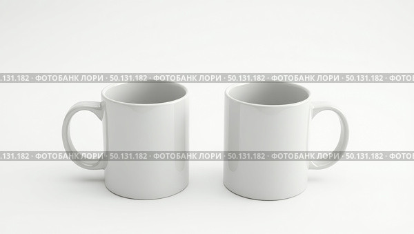 Minimalist pair of identical white ceramic mugs on plain background. Стоковое AI-изображение, AI-художник Андрей Бакусов / Фотобанк Лори