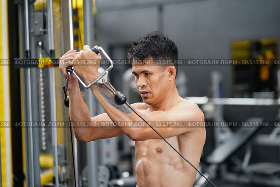 Mixed martial arts fighter going to the gym to build strong muscles To help make the collision more intense and help reduce injuries from punching as well. Стоковое фото, агентство Ingram Publishing / Фотобанк Лори