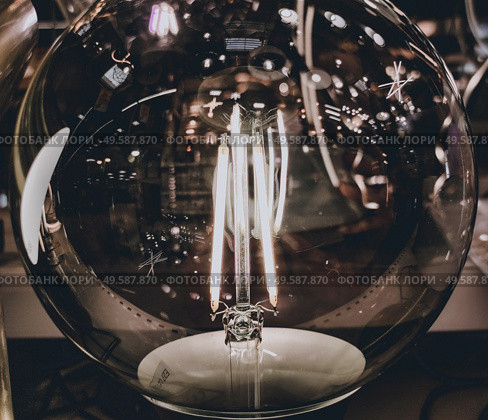 Modern and decorative Filament ligth bulb. Стоковое фото, агентство Ingram Publishing / Фотобанк Лори