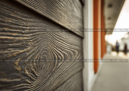 Modern brown wood plank texture. Fiber cement siding. Exterior of composite wall. Plastic material is eco-friendly polymer panels in rows. Wooden grain surface. Hollow WPC boards. Dark oak color. PE. Стоковое AI-изображение, AI-художник Марина Демидюк / Фотобанк Лори