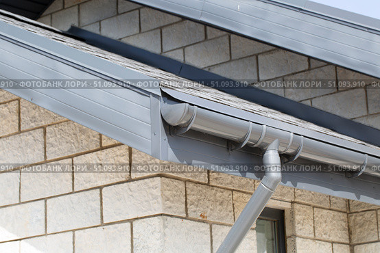 Modern guttering on a modern roof. Roof drainage. Стоковое фото, фотограф Александр Поташев / Фотобанк Лори