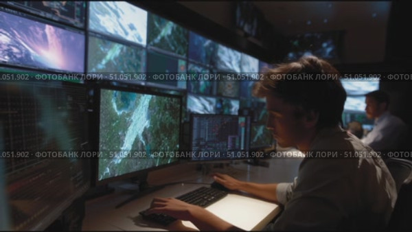 Monitoring data analysis in a modern control room with multiple screens displaying satellite imagery. Стоковое AI-видео, аниматор Сергей Толмачёв / Фотобанк Лори