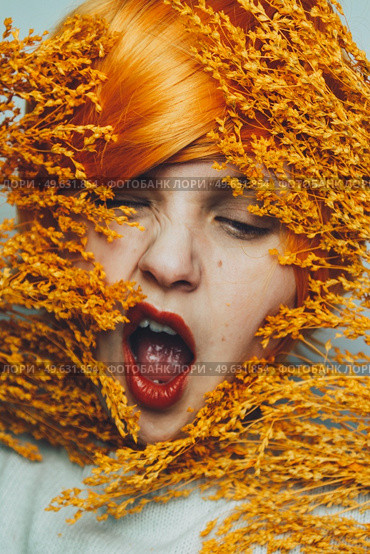Moody portrait in orange tones of a white woman. Стоковое фото, агентство Ingram Publishing / Фотобанк Лори