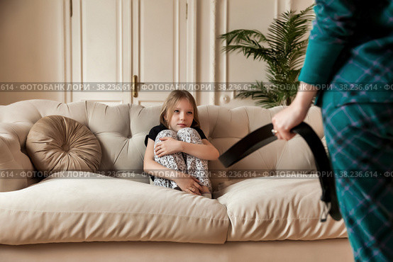 Mother wants to punish her child with belt in her hand. Стоковое фото, фотограф Aleksandr Golubev / Фотобанк Лори