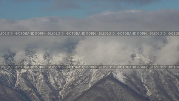 Mountains Clouds Snow Aerial View: Winter landscape, high altitude, showcasing snow-capped peaks obscured by clouds. Стоковое видео, видеограф svetograph / Фотобанк Лори