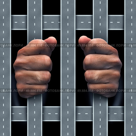 Moving violation concept as a traffic infraction or auromobile dependency symbol as human hands behind bars made of roads and highway streets as a drunk driving icon metaphor for transportation security and transport law. Стоковое фото, агентство Ingram Publishing / Фотобанк Лори