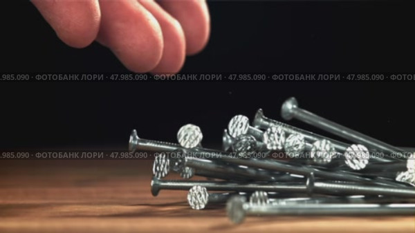 Nails fall on the carpenter's worktable. Filmed on a high-speed camera at 1000 fps. Стоковое видео, видеограф Артем Шадрин / Фотобанк Лори