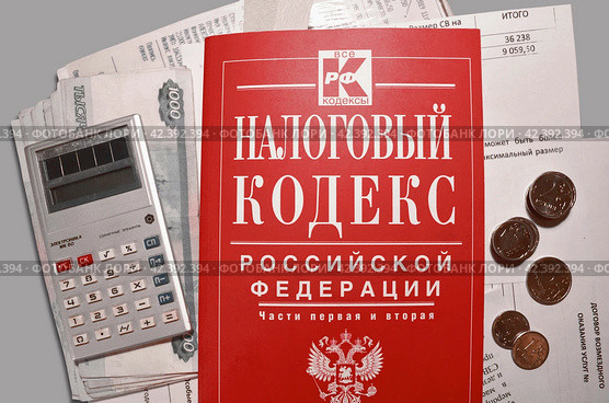 Налоговый кодекс на фоне документов и денег. Подсчёт бюджета. Бизнес. Законодательство. Стоковое фото, фотограф Анна Захарова / Фотобанк Лори