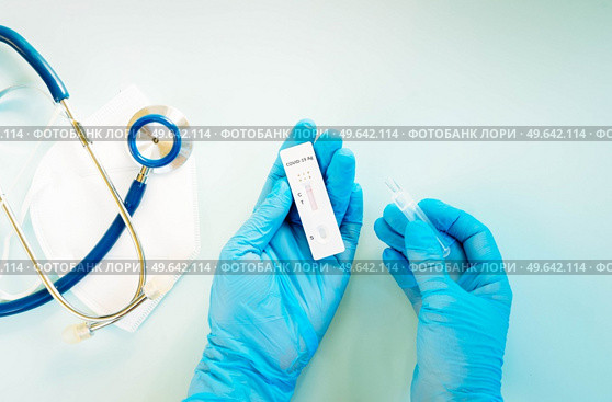 nasal antigen covid 19 test, nurse in blue gloves performs covid 19 test. nasal antigen covid 19 test. Стоковое фото, агентство Ingram Publishing / Фотобанк Лори