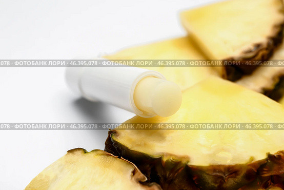 Natural lip balm with pineapple on white background. Стоковое фото, фотограф Pixel_shot / Фотобанк Лори
