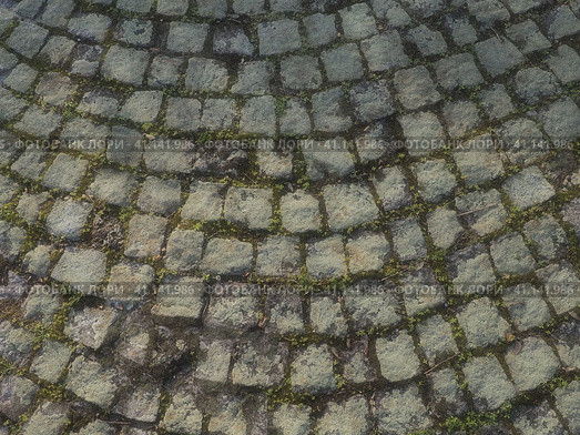 Neatly laid out old paving stones. Pavement on the square of the old town. Square and rectangular stones on the ground, covered with moss and lichens. Стоковое фото, фотограф Юлия Петровская / Фотобанк Лори