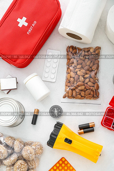 Necessities for emergency bag on white table. Стоковое фото, фотограф Pixel_shot / Фотобанк Лори