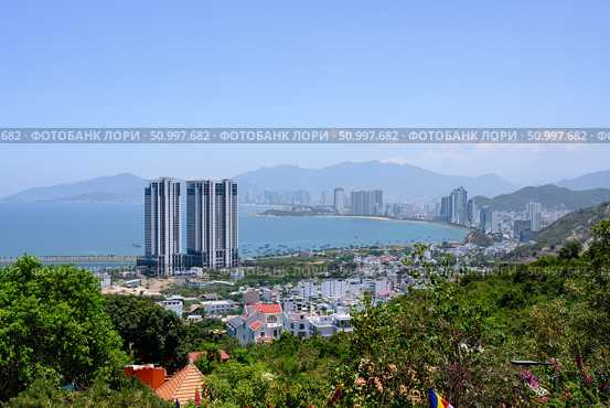 NHA TRANG, VIETNAM - APRIL 28, 2025. View from the mountain to the city with skyscrapers on the shore of the Gulf of the South China Sea. Редакционное фото, фотограф Сергей Фролов / Фотобанк Лори