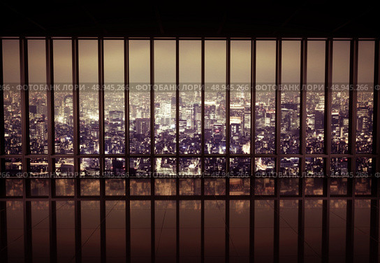 Night city behind the metal grating. Стоковое фото, агентство Ingram Publishing / Фотобанк Лори