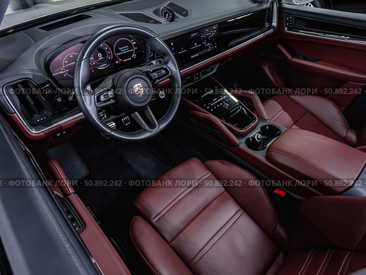 Novosibirsk, Russia -  July 14, 2025: Porsche Cayenne,  Prestige car interior with dashboard, steering wheel, speedometer and tachometer. Редакционное фото, фотограф Виталий Сова / Фотобанк Лори