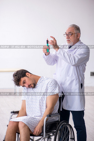 Old male doctor psychiatrist examining young disabled patient. Стоковое фото, фотограф Elnur / Фотобанк Лори