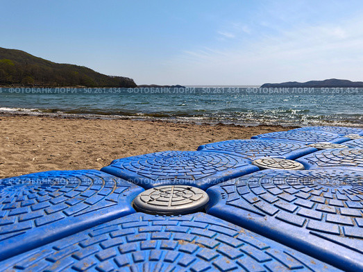 Old plastic blue pontoon on a sandy shore in a bay. Стоковое фото, фотограф Кирилл Зотов / Фотобанк Лори