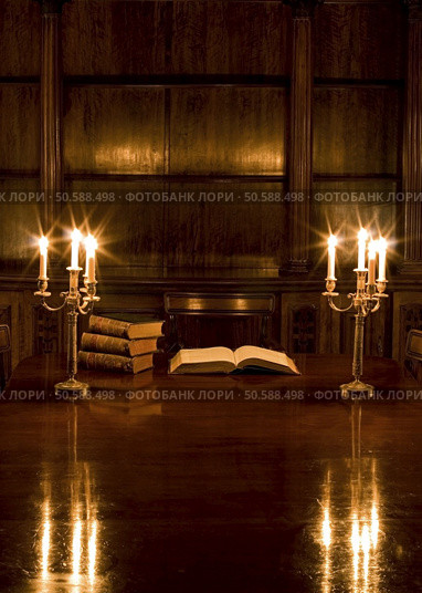 Old room with two candlesticks and vintage books. Стоковое фото, агентство Ingram Publishing / Фотобанк Лори