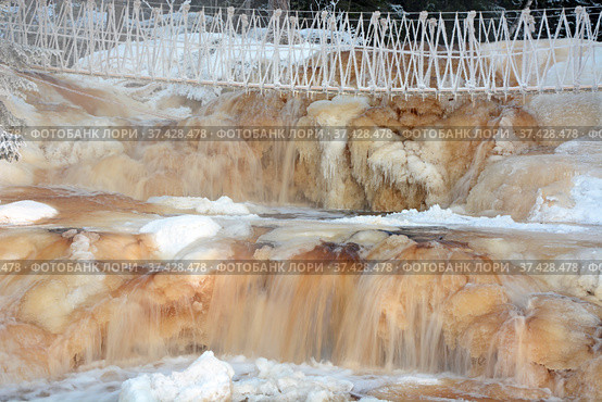 One of the most famous places in the Republic of Karelia is the Ruskeala waterfalls (the filming location of the Soviet film "The Dawns Here Are Quiet...") in the winter season. Traveling in Russia, Republic of Karelia. Стоковое фото, фотограф Алексей Кокоулин / Фотобанк Лори