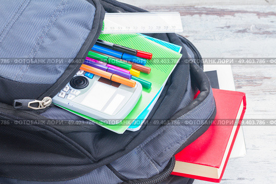 Open school backpack with supplies close up. School backpack with supplies. Стоковое фото, агентство Ingram Publishing / Фотобанк Лори