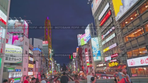 Osaka, Japan - Sep 22 2024, 4k, Panoramic view of Dotonbori street with various cafes, restaurants, bright signs and advertisements, illumination, a lot of people walking, at night, Osaka, Japan. Редакционное видео, видеограф Сергей Богомяко / Фотобанк Лори