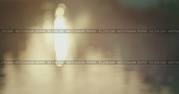 Out of focus shimmering sun reflection on the surface of water at golden hour. Стоковое AI-видео, аниматор Ольга Сухарева / Фотобанк Лори
