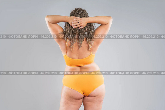 Overweight thigh, woman with fat hips, back and buttocks, obesity female body with cellulite on gray background. Стоковое фото, фотограф Станислав Тарко / Фотобанк Лори