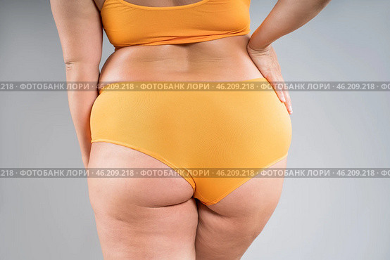Overweight thigh, woman with fat hips, legs and buttocks, obesity female body with cellulite on gray background. Стоковое фото, фотограф Станислав Тарко / Фотобанк Лори
