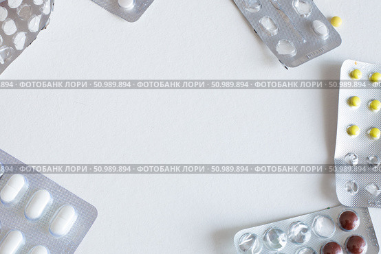 Pack of blisters with different pills on a white background with. Стоковое фото, фотограф Коханова Наталья / Фотобанк Лори