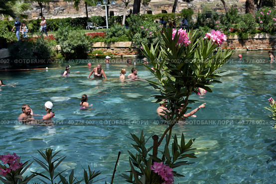 Pammukale, Turkey - July, 19, 2015: People in antique Cleopatra's pool with thermal water in ancient city Hierapolis, near modern Turkey city Denizli. Редакционное фото, фотограф Анна Кривицкая / Фотобанк Лори