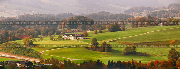 Panoramic view of beautiful mountain rural landscape in Alps with village in the backgroundFantastic views of Austrian green hills. Beauty world. Colorful mountain landscape of austrian alps in Mondsee. Стоковое фото, агентство Ingram Publishing / Фотобанк Лори