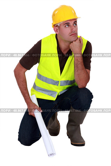 Pensive laborer crouching on white background. Стоковое фото, агентство Ingram Publishing / Фотобанк Лори