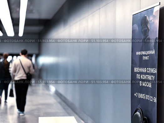 People walk along the corridor past a poster with the inscription "Military service in the Armed Forces of the Russian Federation." Russia. Moscow. 17.08.25. Редакционное фото, фотограф Ярославский Максим / Фотобанк Лори