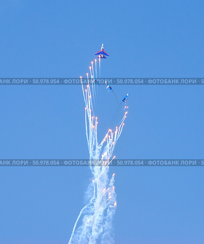 Performance of aerobatic team Russian Knights at the air showOmsk, Russia - 19 March, 2016: Performance of Russian Knights at the air show. Редакционное фото, фотограф Александр Карпенко / Фотобанк Лори