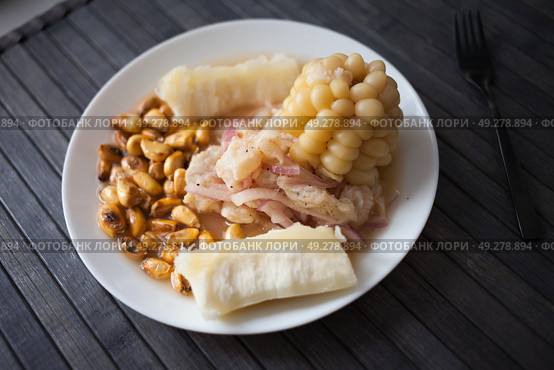 Peruvian traditional dish.fish ceviche with yuka and corn. Стоковое фото, фотограф Татьяна Яцевич / Фотобанк Лори