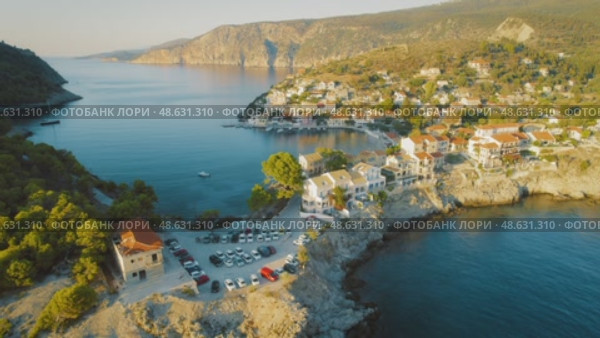 Picturesque village Assos by the turquoise sea at sunset in Kefalonia Island Greece. Стоковое видео, видеограф Igor Tichonow / Фотобанк Лори